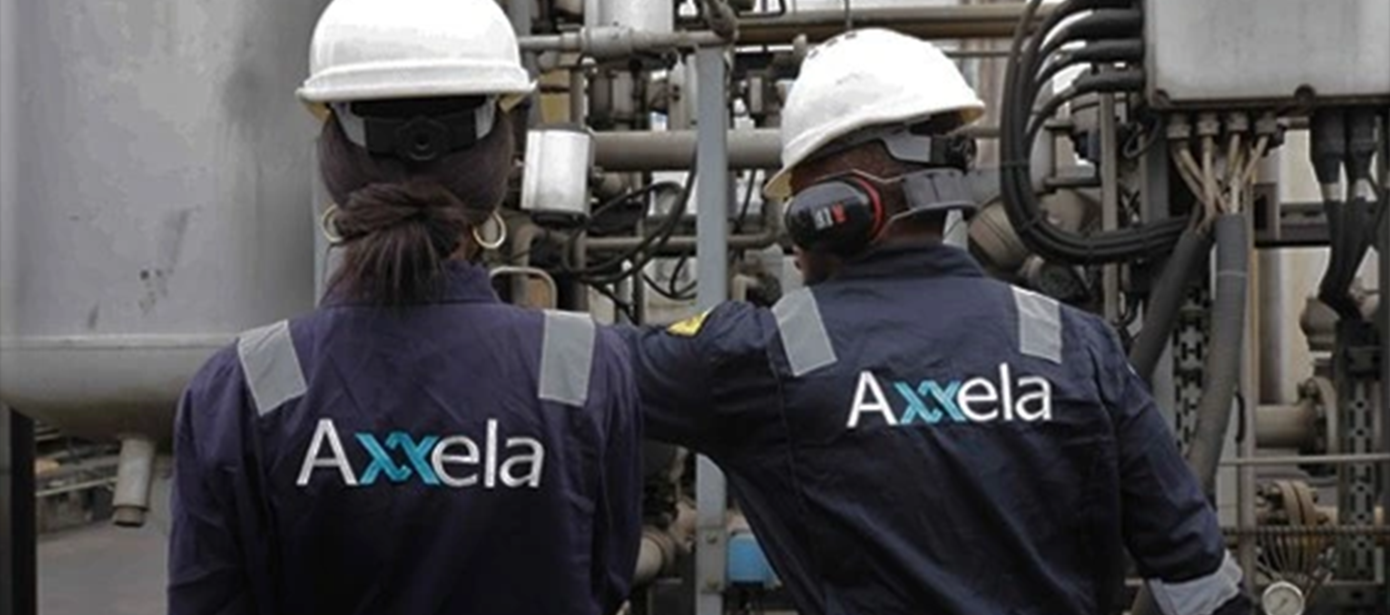 Two engineers in Axela uniforms at gas facility - Levene Energy acquisition